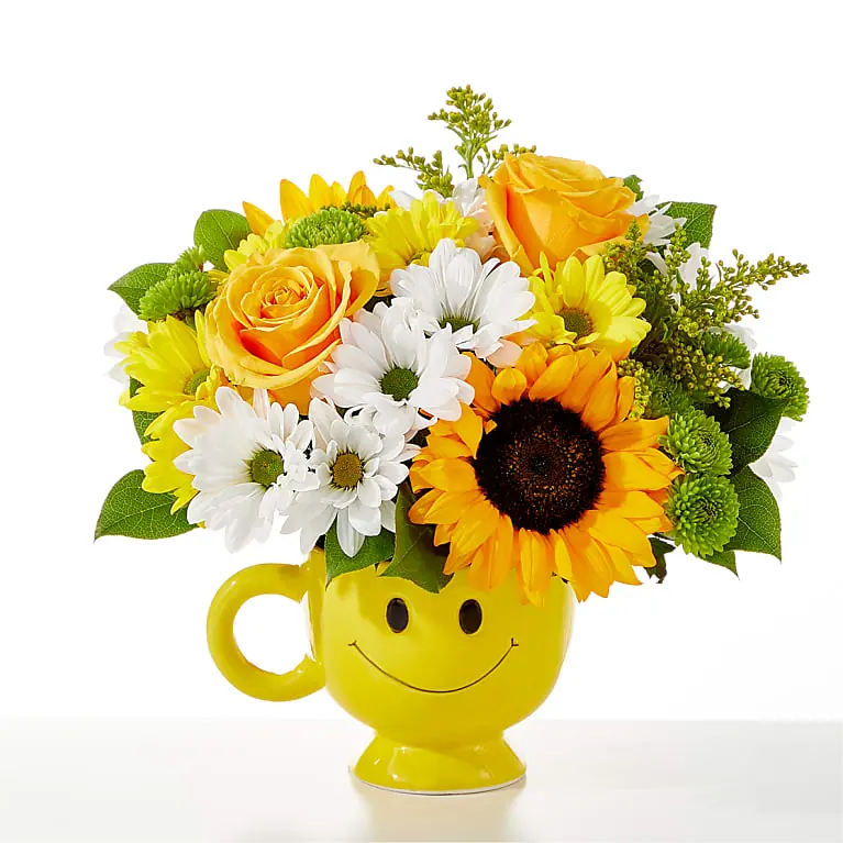 FTD Be Happy Bouquet with sunny flowers in a smiley mug
