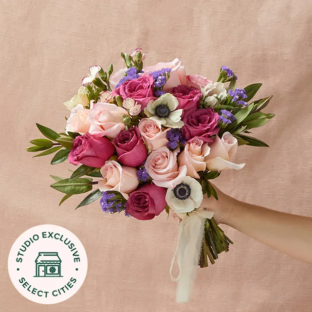 Darling Bridal Bouquet from The Bouqs Co. with pink and purple roses and white anemones